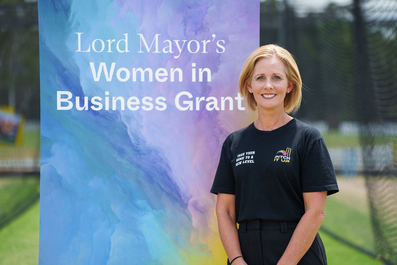 Emma Thomson, Pitch It Up pictured in front of a Lord Mayor's Women in Business Grant sign.