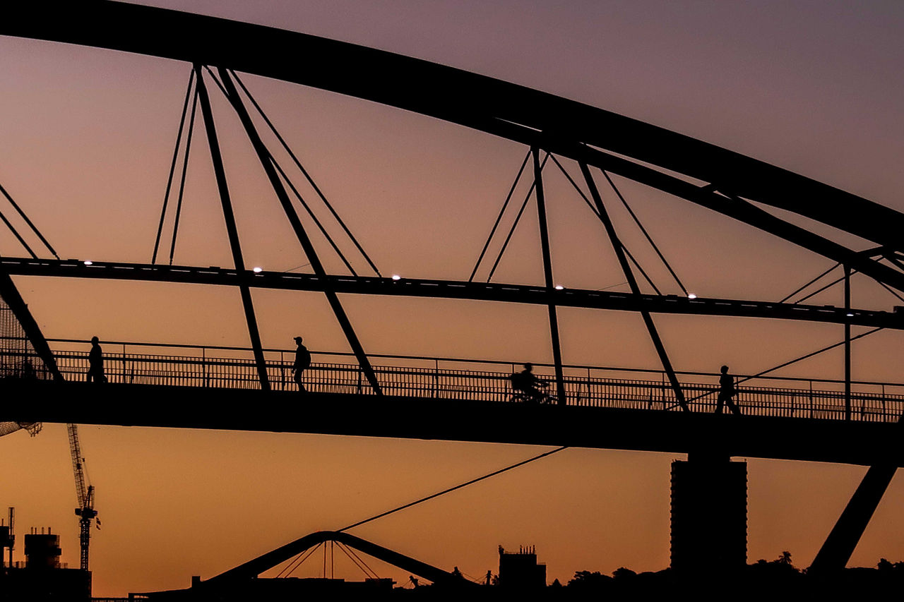 LMPA 2026 Peoples Choice Finalist - Jann Carlo Macatangay - Goodwill Bridge Silhouettes. People seen crossing the Goodwill Bridge with faded sunlight behind.