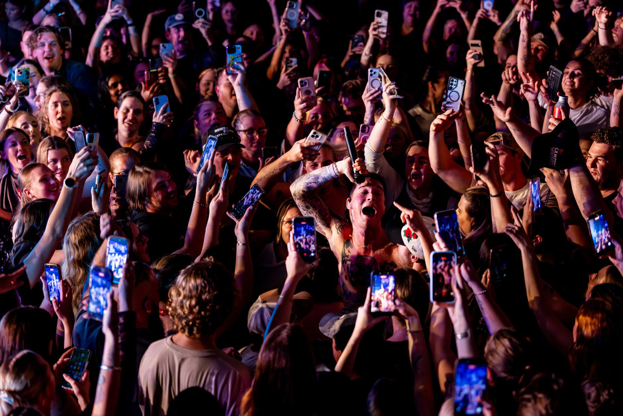 LMPA 2026 Peoples Choice Finalist - Lachlan Douglas - Everynight Brisbane.  Audience members surrounding a singer with a microphone.