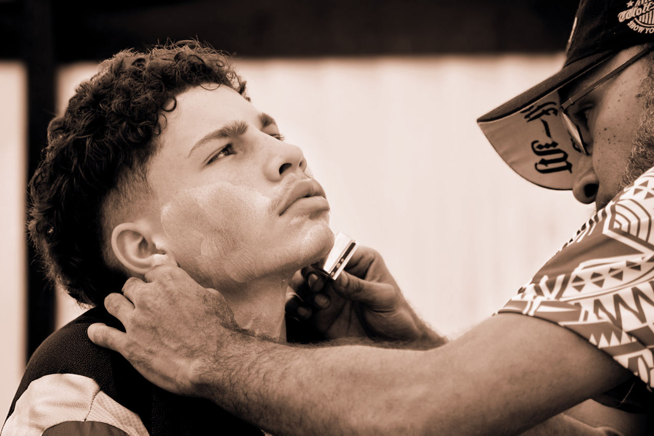 LMPA 2026 Peoples Choice Finalist - Rosemary Featherstone - The First Shave. A teenage boy receiving a face shave.