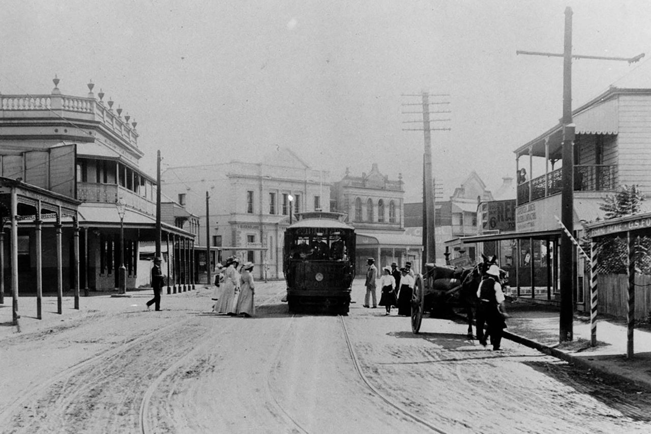 An image of Albion Corner in 1909.  Shows a tram and people crossing street.