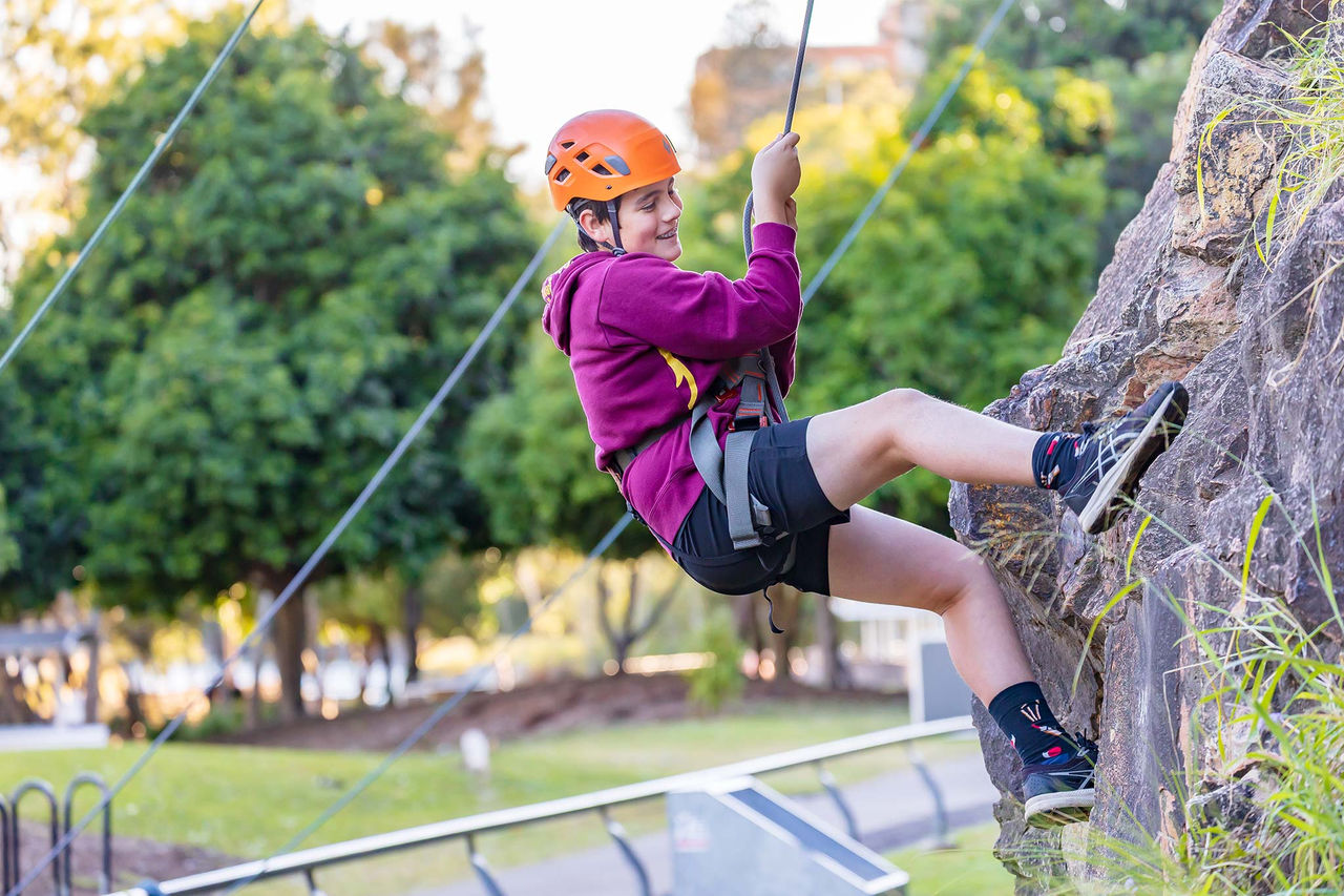 Primary school-aged child abseiling at Kangaroo Point Cliffs.