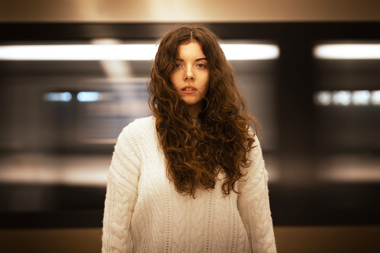 Faith Kayrooz - finalist in The QUBE Effect 2026 - standing in an underground train station.