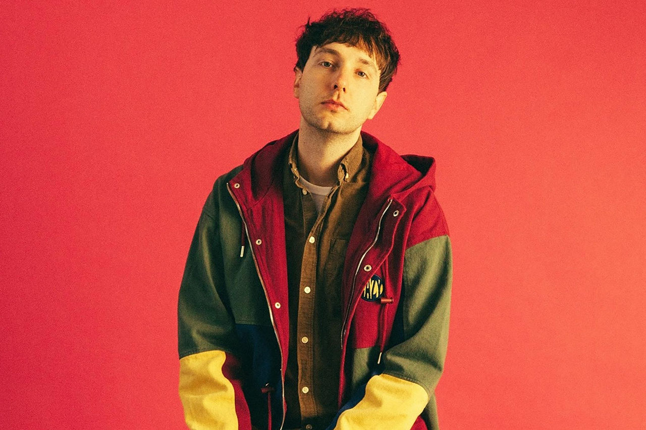 Jeremy Neale starting in front of a red background.