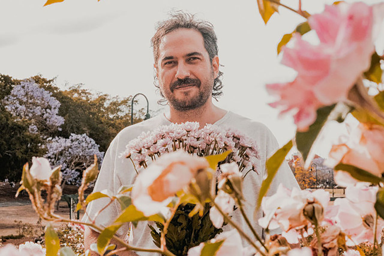 Luke Daniel Peacock - mentor for The QUBE Effect 2026 - photographed in a garden setting.