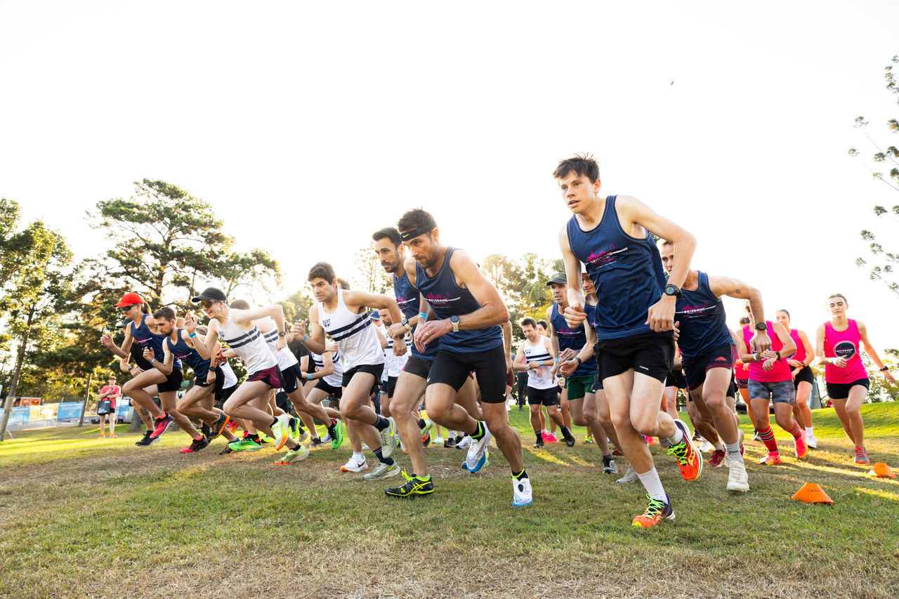 Adult runners at the start of a race at a Victoria Park family-friendly festival.