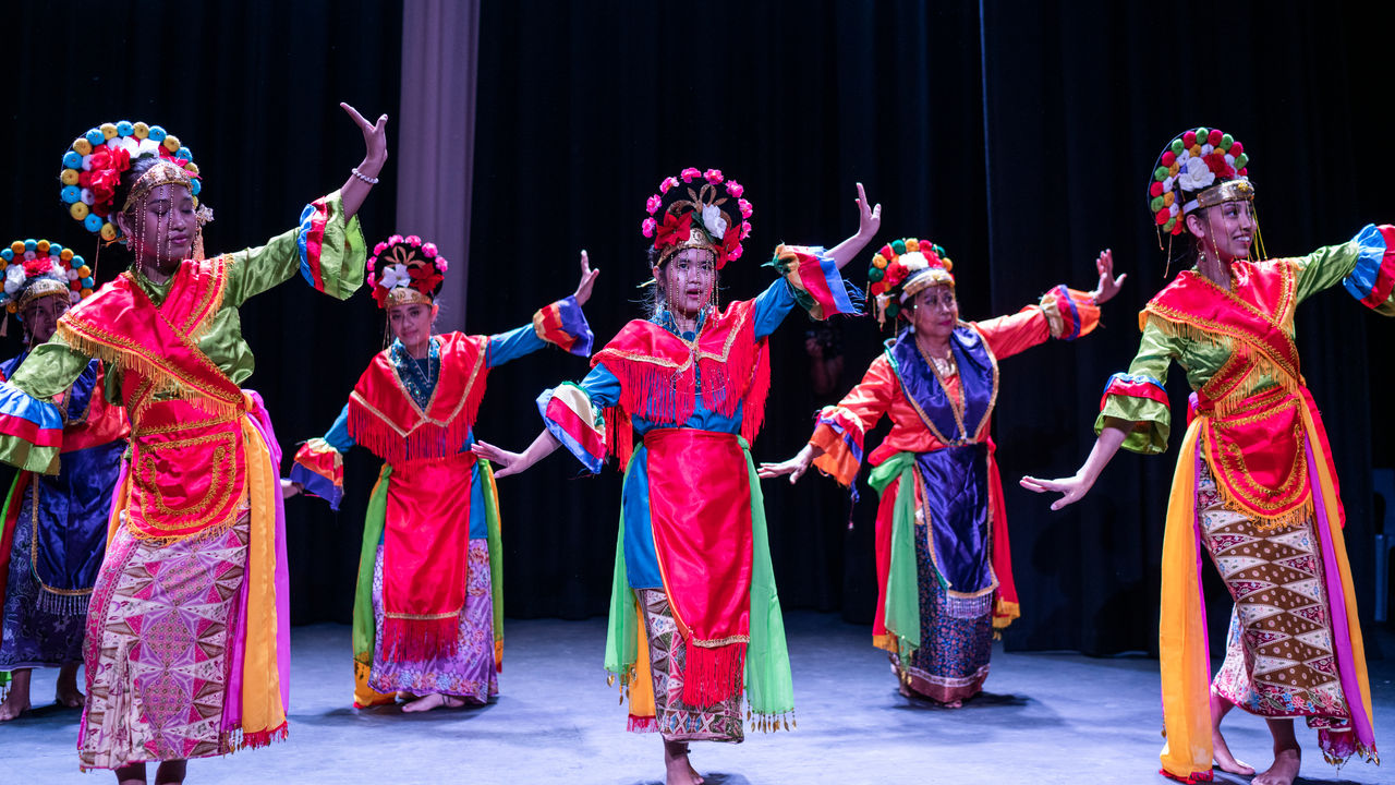 Asian dancers perform in Ron Hurley Theatre at Seven Hills Hub.