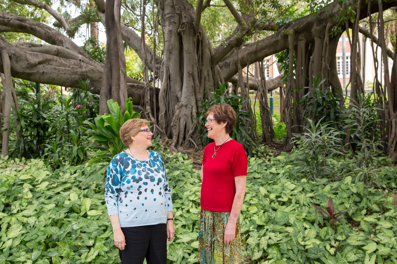 2 mature women talking in front of a fig tree at City Botanic Gardens.