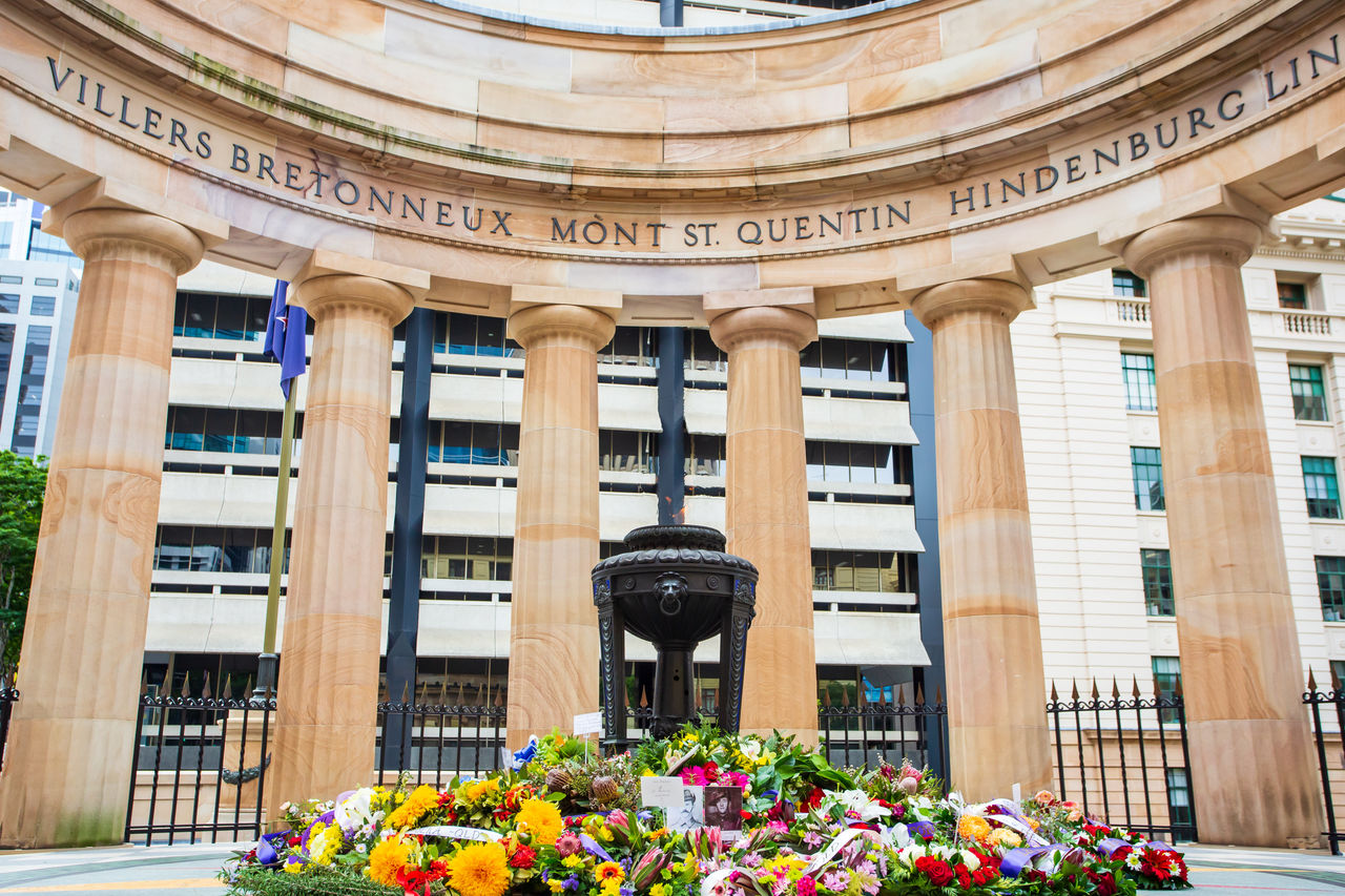 Anzac Square Eternal Flame with flowers on Anzac Day.