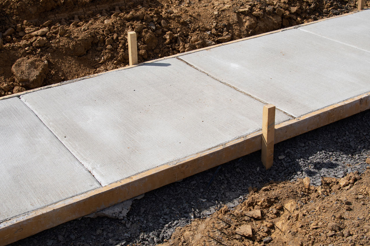 Timber frame around newly laid concrete footpath