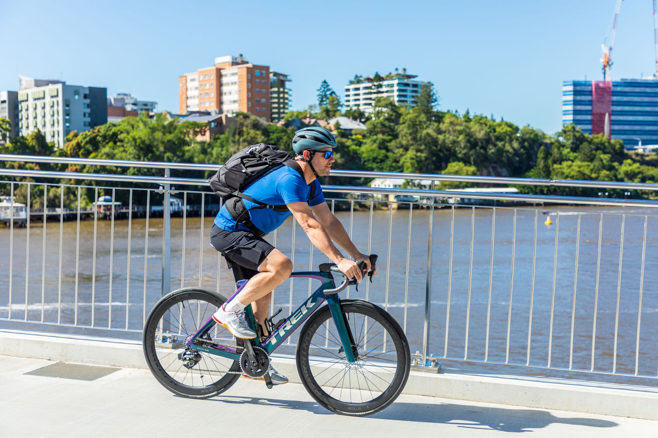 A child jumping a bike at an event in a park.