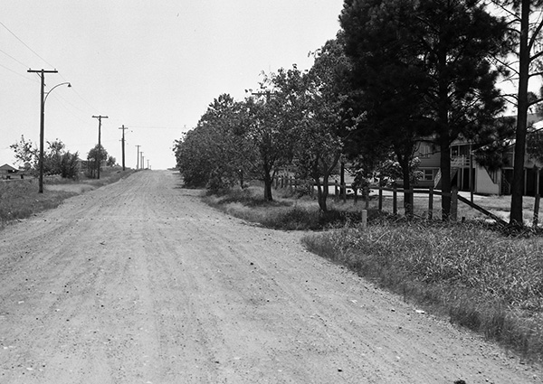Earnshaw Road between Tufnell and Red Hill Roads with Nudgee State School on the right, 1959.