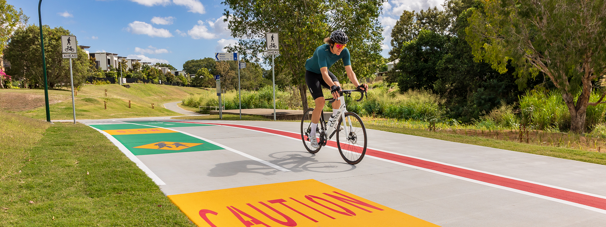A cyclist riding on the completed Kedron Brook bikeway - Corbett Park