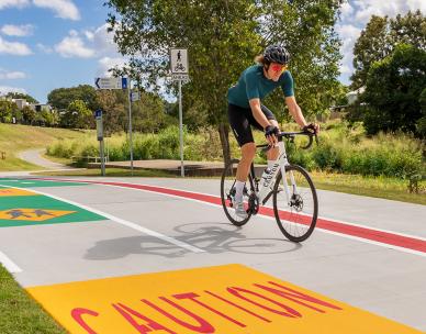 Cyclist riding on completed Kedron Brook bikeway
