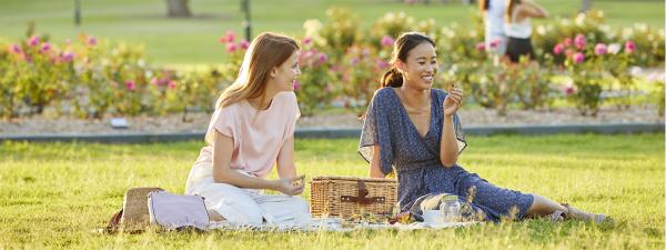Two women having a barbecue near the rose garden at New Farm Park, New Farm