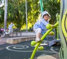 Young girl climbing on play equipment in Baldwin Lawn Playground, City Botanic Gardens, Brisbane City
