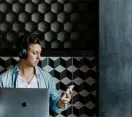 Man with laptop, phone and headphones